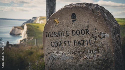 Old stone sign with Durdle Door on the second plan, Jurassic Coast, Dorset, England, Europe