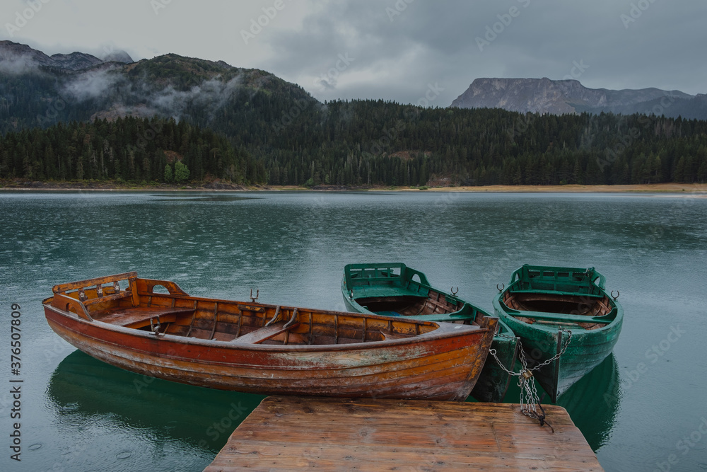 Wooden boats on the Black lake in Montenegro Wooden boats on the Black lake in Montenegro
