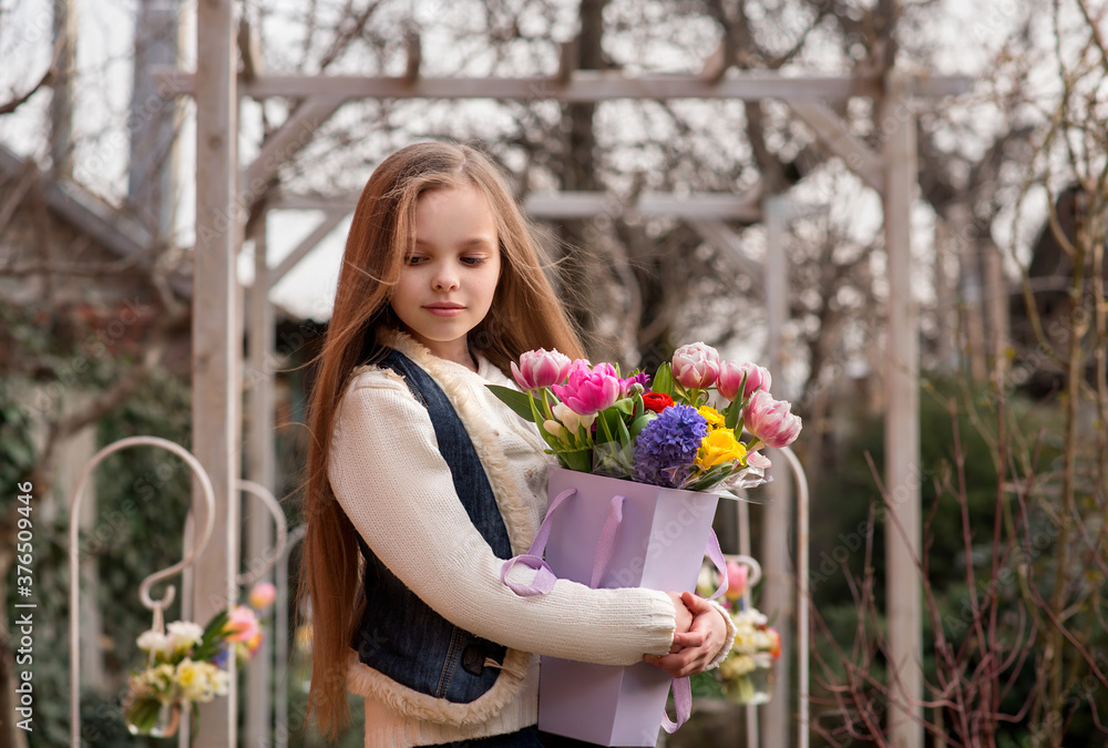 Cute smiling little girl with bouquet of spring flowers in hands outdoor. Cute smiling little girl with bouquet of spring flowers in hands outdoor.