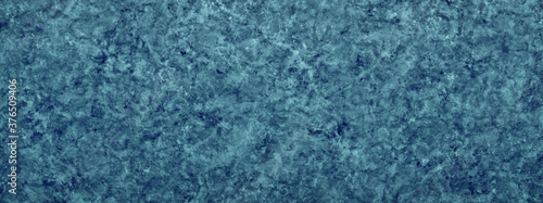 Abstract blue paint splatter background reminiscent of a water splash effect
