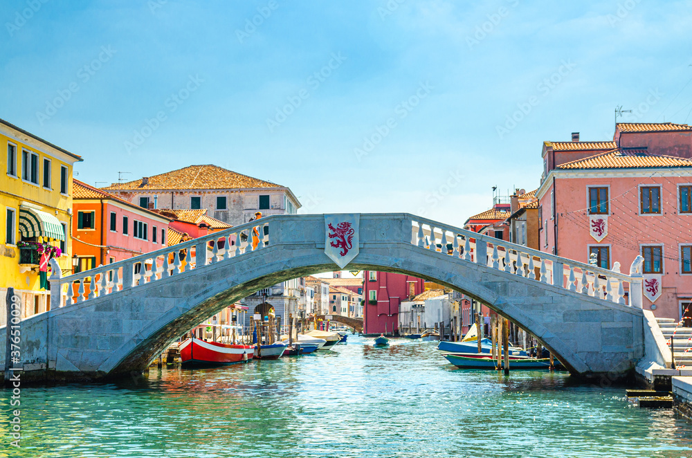 Stone bridge Ponte di Vigo across Vena water canal in historical centre of Chioggia