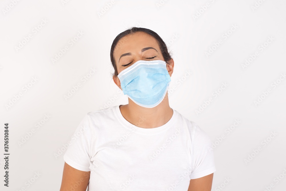 Young arab woman wearing medical mask standing over isolated white background very happy and excited about new plans. Young arab woman wearing medical mask standing over isolated white background very happy and excited about new plans.