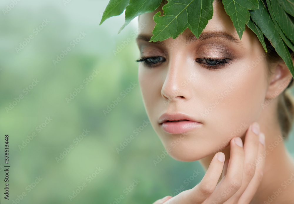 Young beauty smiling blonde model with natural make up and green leaf. Young beauty smiling blonde model with natural make up and green leaf.