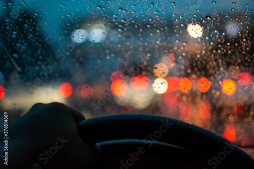 Blur the background of car tail lights, bokeh and raindrops while driving.