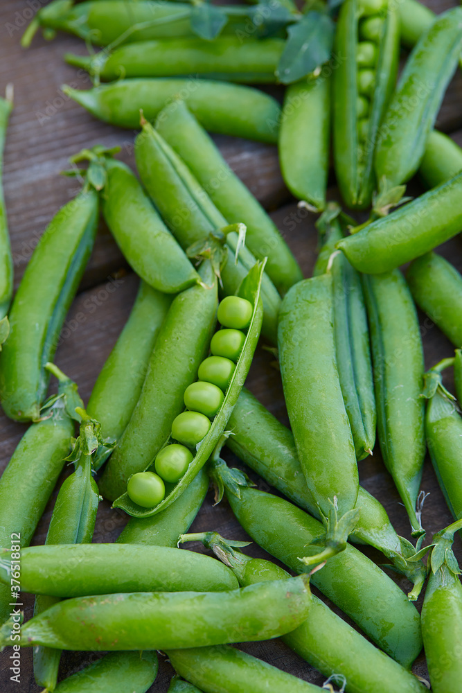 fresh green peas on wooden surface fresh green peas on wooden surface