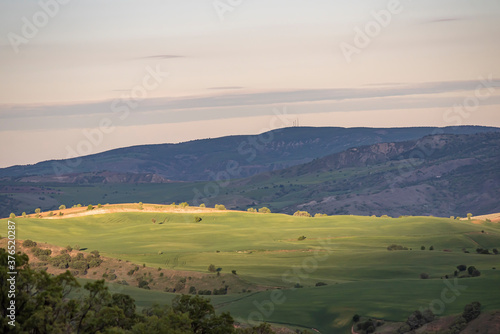 Aerial view of endless lush pastures and farmlands of Turkey. Rural landscape on sunset. © attraction art