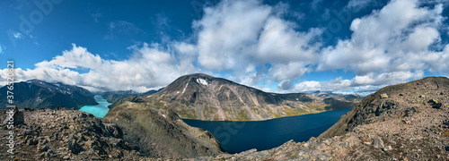 ultra wide panorama of the besseggen ridge trail over the gjende lake cliff on the mountains of jotunheimen national park Norway, panoramic