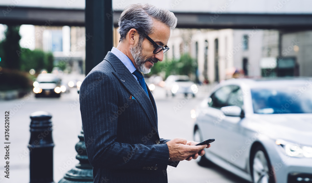 Handsome middle aged male tapping on cellphone. Handsome middle aged male tapping on cellphone.