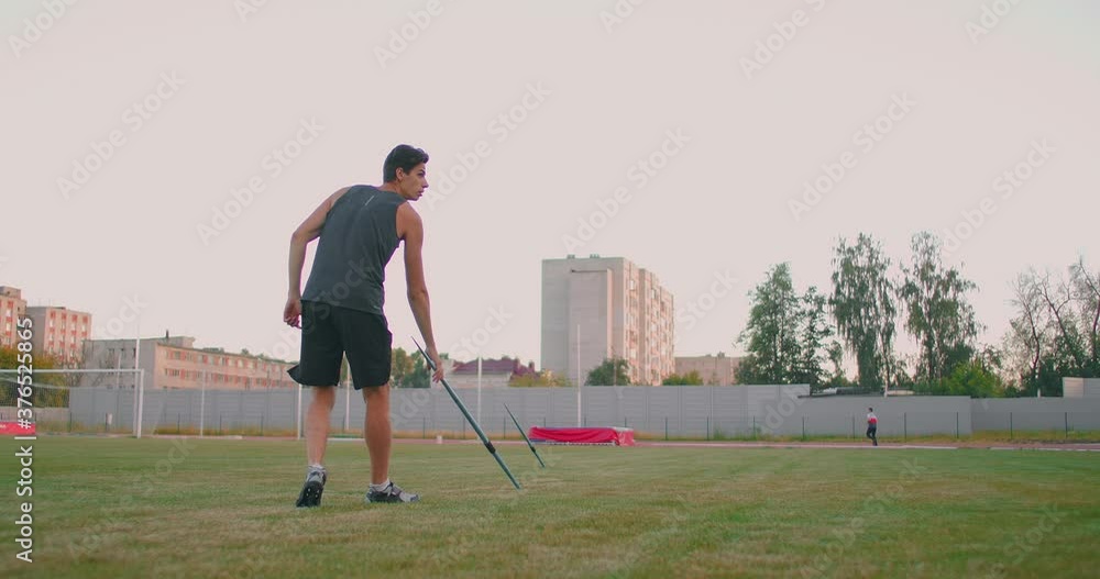 Jeweling Throw Slow motion: a Male athlete at the stadium concentrates and prepares to ...