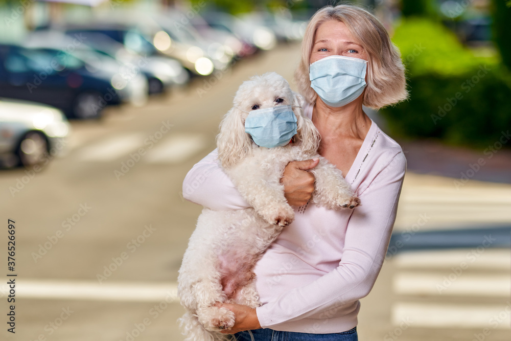 Portrait elderly woman with a dog outdoors an antivirus mask Portrait elderly woman with a dog outdoors an antivirus mask