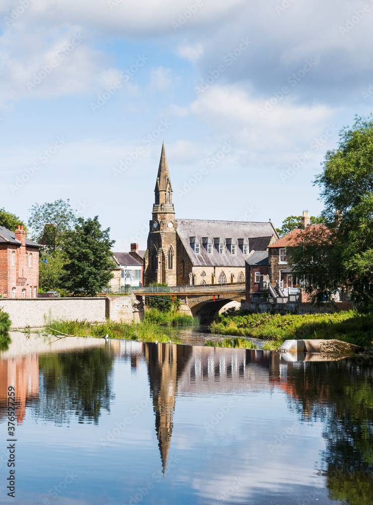 River Wansbeck at Morpeth, Northumberland, UK and St Georges United Reformed Church.