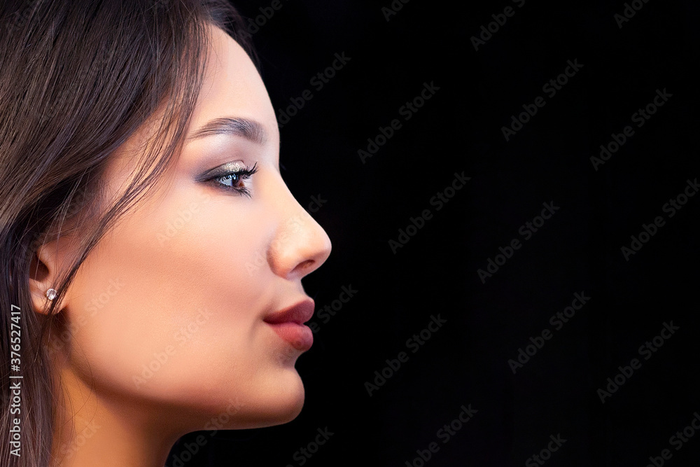 Close up portrait in profile of young beautiful woman with smoky eye makeup Close up portrait in profile of young beautiful woman with smoky eye makeup