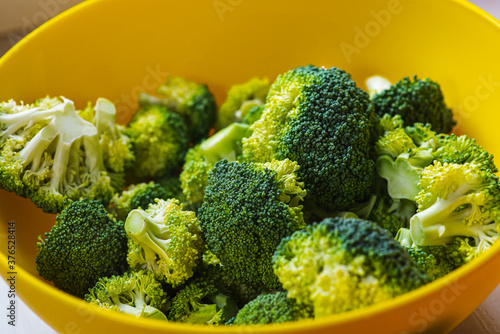 green broccoli in a yellow bowl, healthy eating concept, food