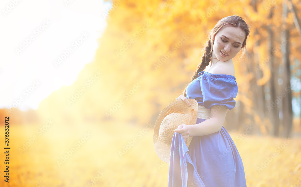 Young beautiful girl in dresses on nature. A girl in a hat walks in the park. Young woman on a picnic with a basket outside the city. Young beautiful girl in dresses on nature. A girl in a hat walks in the park. Young woman on a picnic with a basket outside the city.