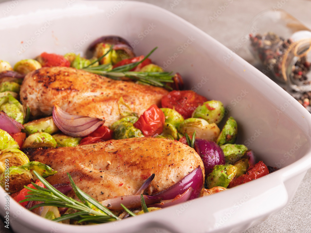roasted baked turkey, chicken fillet with vegetables, brussels sprouts, onions tomato close up