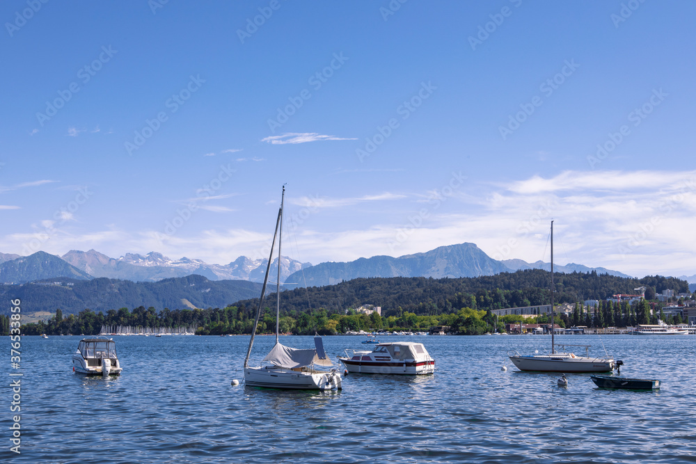 Panorama of Lake Lucerne, yachts in the water, view on Alps, summer day. Switzerland