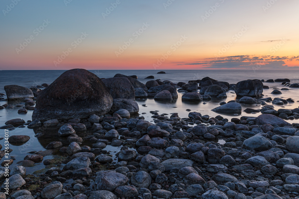 Rocky shore and peninsula of Baltic sea at sunset. Nordic minimalistic wilderness.