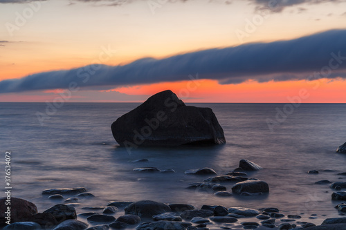 Rocky shore and peninsula of Baltic sea at sunset. Nordic minimalistic wilderness. photo