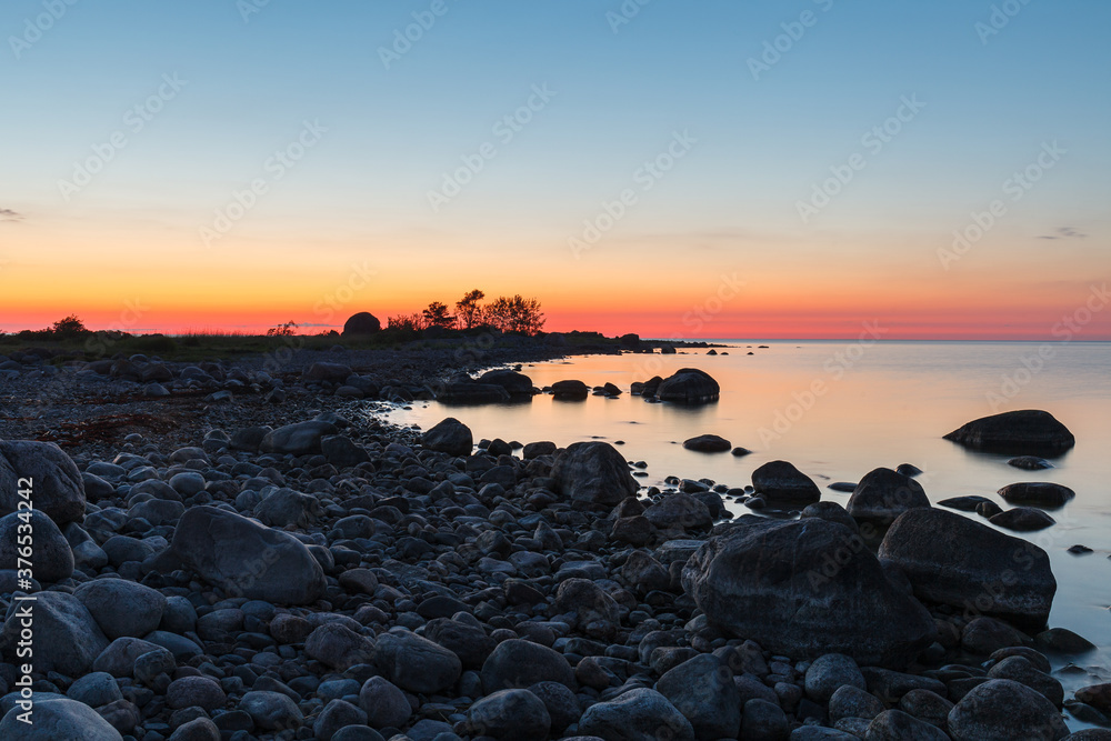 Obraz premium Rocky shore and peninsula of Baltic sea at sunset. Nordic minimalistic wilderness.