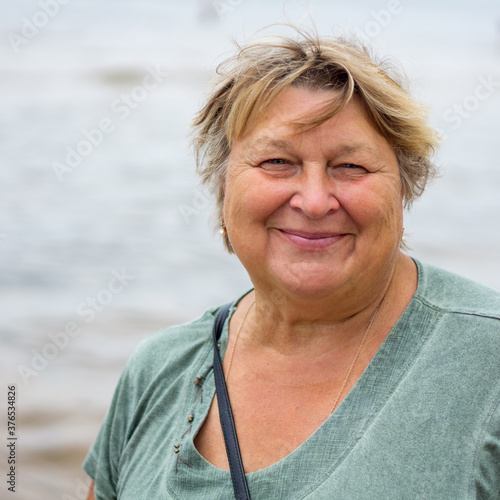 Mature plump woman resting on the beach of the sea