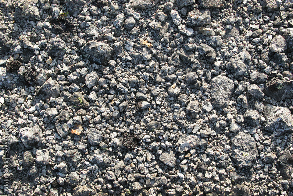 Crushed stone background. Small rocks on a mountain trail Crushed stone background. Small rocks on a mountain trail