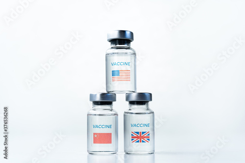 Transparent vials with USA, UK, China flag. New vaccine for covid-19 coronavirus, flu,infectious diseases. Injection after clinical trials for mass vaccination of human,people. Medicine, drug concept
