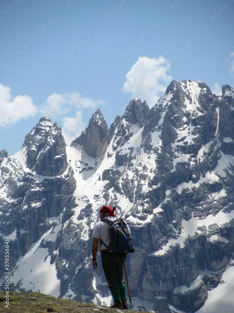 Active middle aged man in a traditional Tirol costume hiking in Tre Cime di Lavaredo National Park, Dolomites