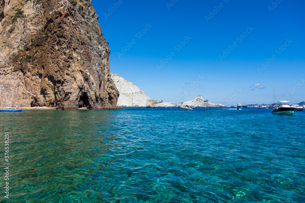 Crystalline green water along the rocky coast of Palmarola island (Ponza, Latina, Italy).