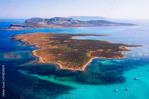 View from above, stunning aerial view of the Isola Piana island and the Asinara island bathed by a beautiful turquoise clear water. Stintino, Sardinia, Italy.