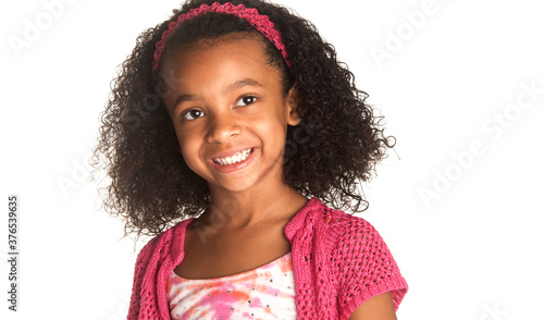 Smiling happy little girl with beautiful curly frizzy hair