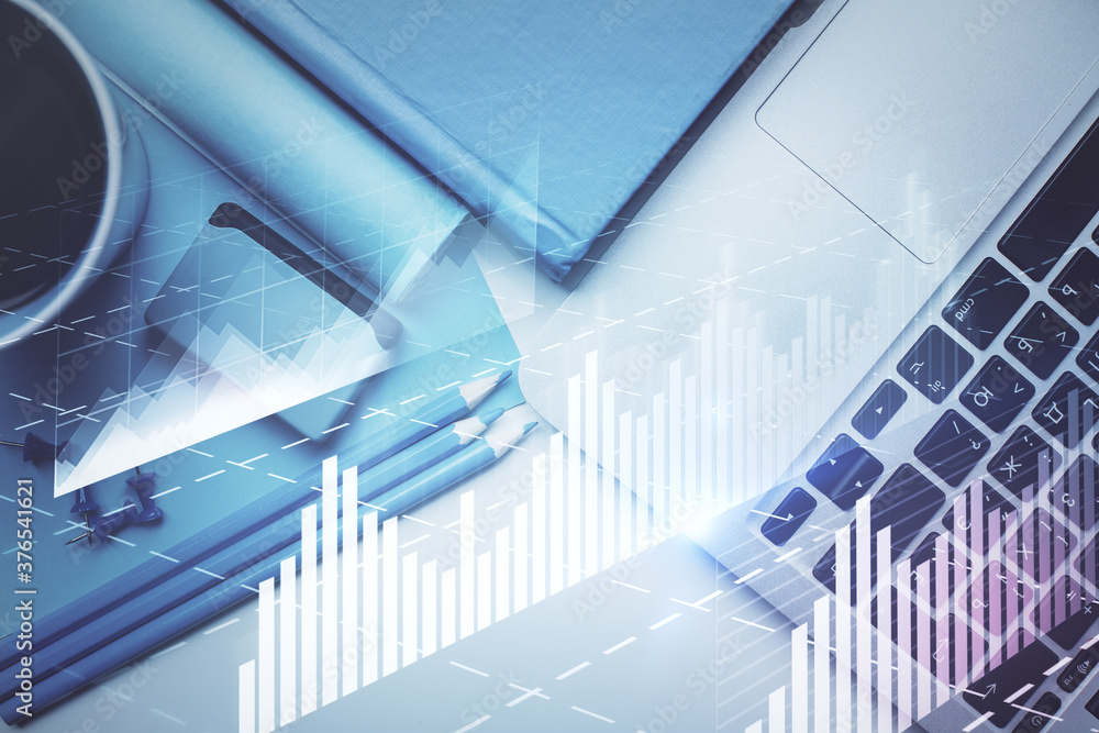 Double exposure of forex graph drawing over desktop background with computer. Concept of financial analysis. Top view. Double exposure of forex graph drawing over desktop background with computer. Concept of financial analysis. Top view.