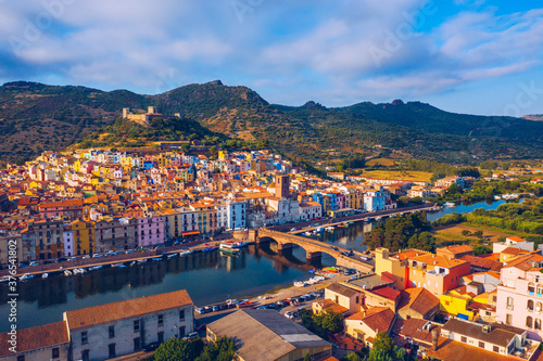 Aerial view of the beautiful village of Bosa with colored houses and a medieval castle. Bosa is located in the north-wesh of Sardinia, Italy. Aerial view of colorful houses in Bosa village, Sardegna. © daliu