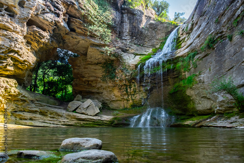 A large beautiful waterfall amongst rocks. Nature background.