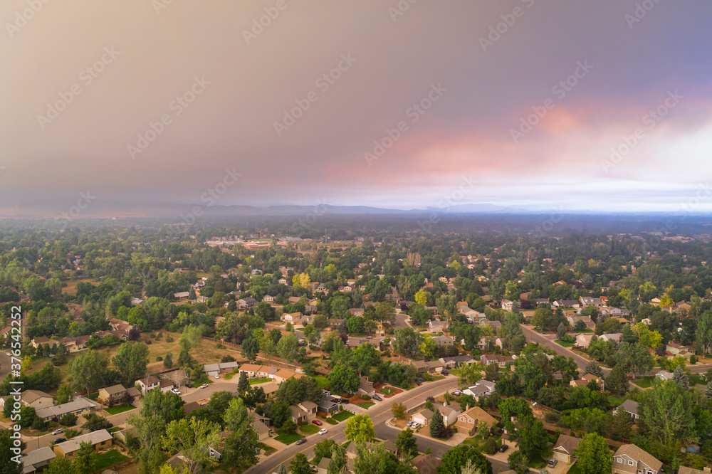 wildfire smoke from Cameron Peak Fire over Fort Collins in northern Colorado, midday aerial view