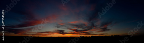 A bright and beautiful sunset. The clouds are illuminated by the last rays of light, creating a magical image.