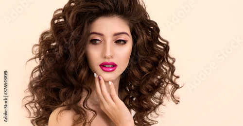 Portrait of Beautiful Fashion Model with Bright Eye Make up and Long Wavy Hair.