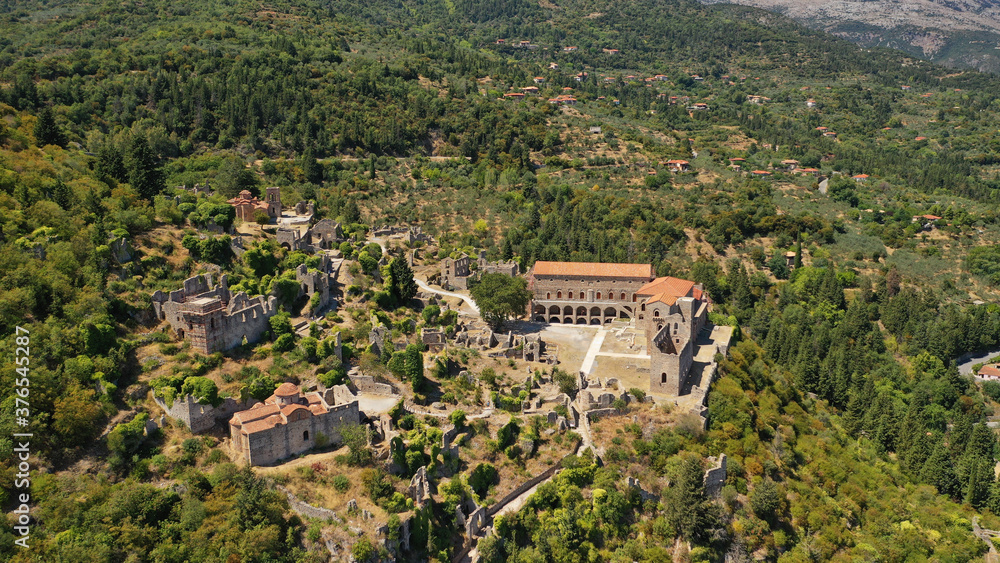 Aerial drone photo of medieval byzantine old city of Mystras featuring Monastery of Pantanassa, Temple of Agia Sofia and uphill castle of Mystras, Sparta, Peloponnese, Greece