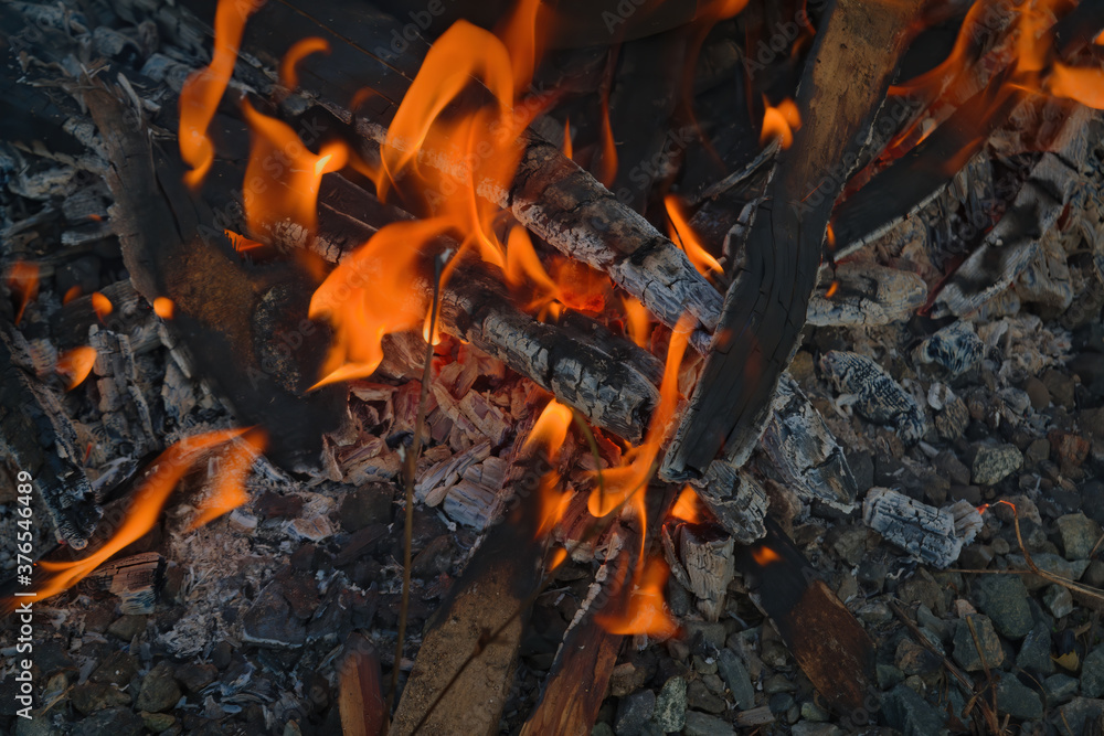 Burning log of wood close-up as abstract background. The hot embers of burning wood log fire. Burning log of wood close-up as abstract background. The hot embers of burning wood log fire.