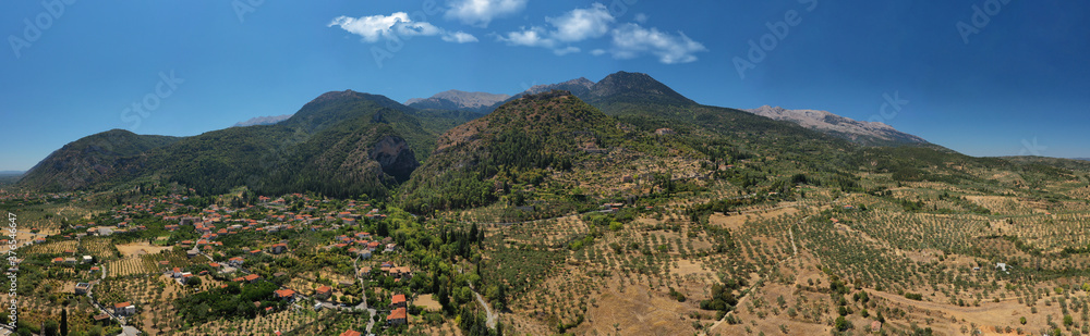 Obraz premium Aerial drone photo of medieval byzantine old city of Mystras featuring Monastery of Pantanassa, Temple of Agia Sofia and uphill castle of Mystras, Sparta, Peloponnese, Greece