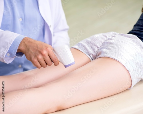 Young woman visiting doctor dermatologist