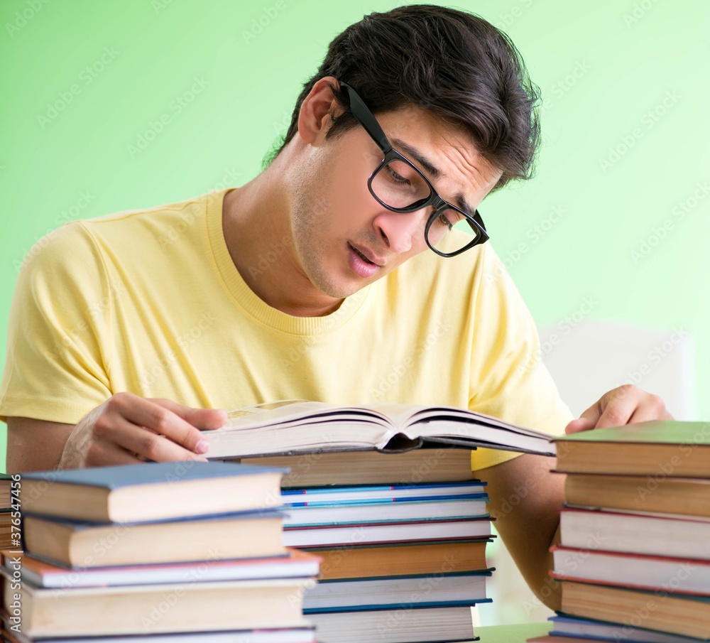 Student with too many books to read before exam Student with too many books to read before exam
