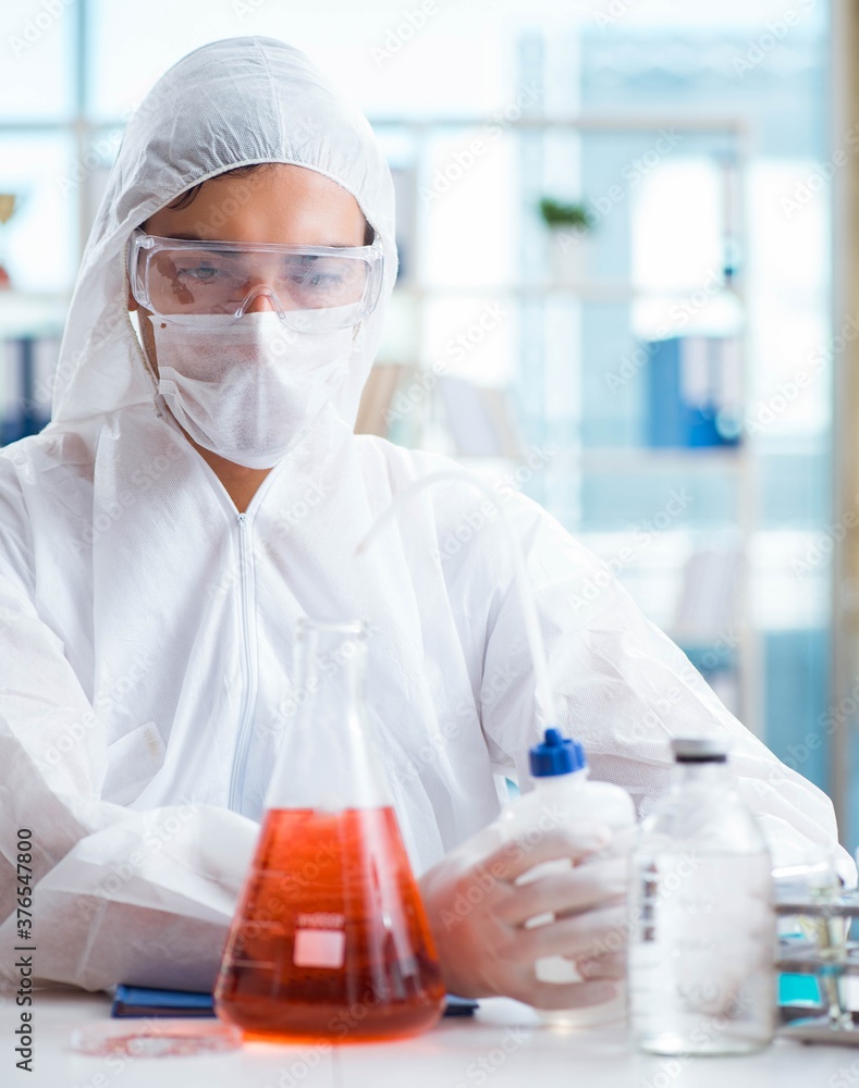 Chemist working in the laboratory with hazardous chemicals Chemist working in the laboratory with hazardous chemicals
