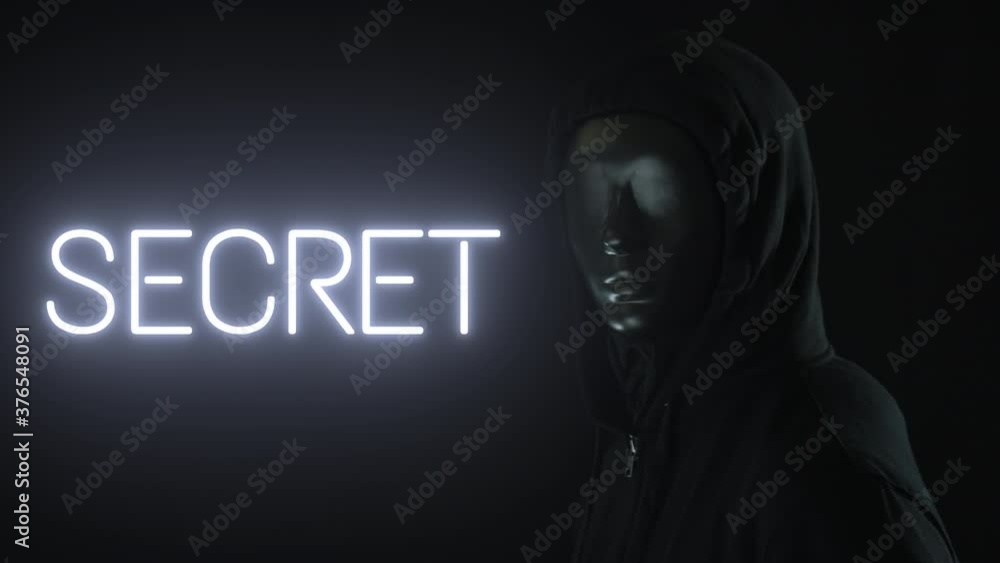 Man wearing black mask and the light revealing SECRET word Man wearing black mask and the light revealing SECRET word