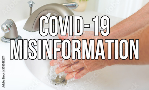 Covid-19 Misinformation theme with person washing their hands with soap and water photo