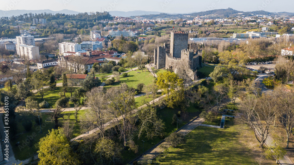 Fototapeta premium Aerial view of Guimarães castle, Portugal. Medieval stone castle in Guimarães