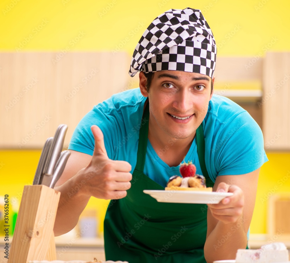 Man cook preparing cake in kitchen at home Man cook preparing cake in kitchen at home