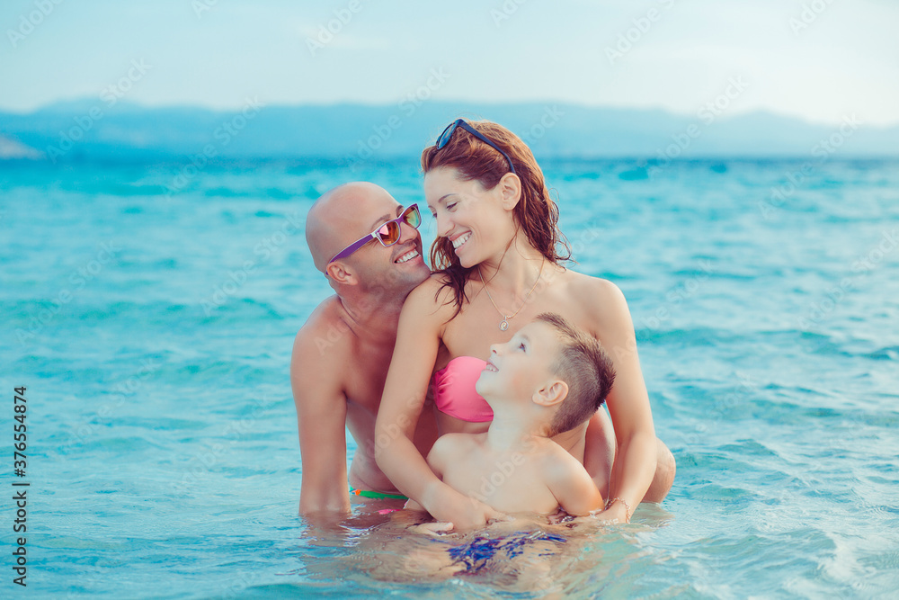 Cute Family on the beach having fun together Cute Family on the beach having fun together