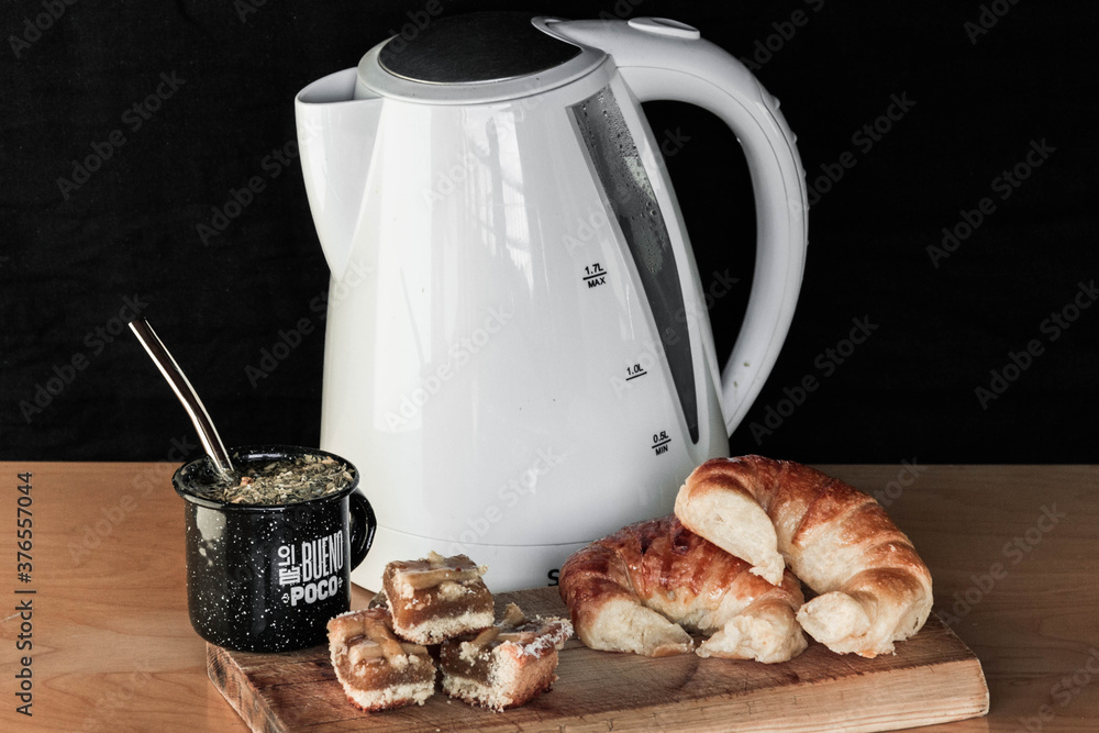 Argentinean breakfast/dinner. Still life with mate, kettle, thermos, yerba mate, half moons and
