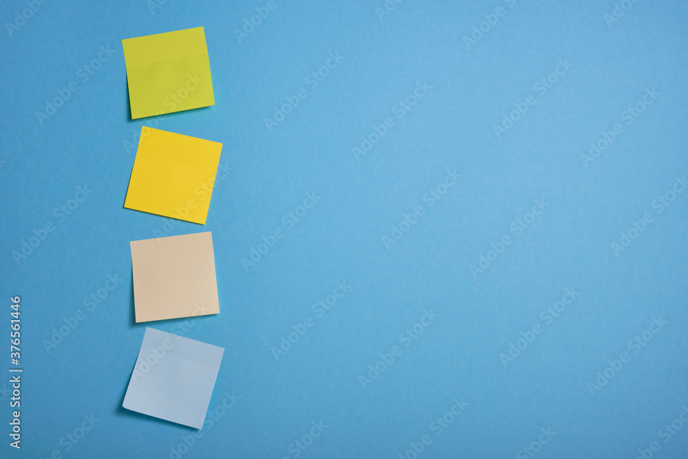 bright colored sticky notes on blue background bright colored sticky notes on blue background