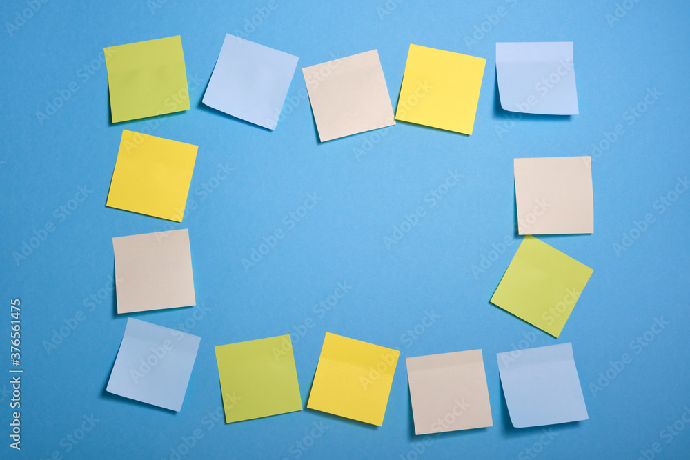 bright colored sticky notes on blue background bright colored sticky notes on blue background